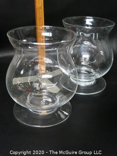 Two Clear Glass Footed Hurricane Candle Holders. 