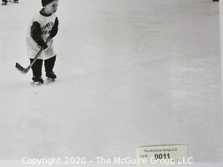 Black & White Photo of Kids playing Hockey. Measures approximately 16" X 20" on Photo Board.