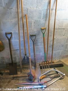 Assorted rakes, shovels, brooms