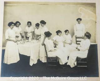 Black and White Photo of Nurses on Break.  Mounted on Photo Board. Measure approximately 14" x 11" with Board.  Some damage to edge. 