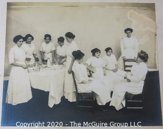 Black and White Photo of Nurses on Break.  Mounted on Photo Board. Measure approximately 14" x 11" with Board.  Some damage to edge. 