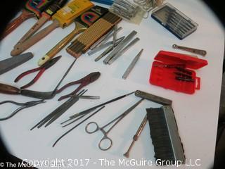 Assortment including paint brushes, screwdrivers, stapler, sledge hammer metal files, metal punches, wall paper tools, plumb bob.... 