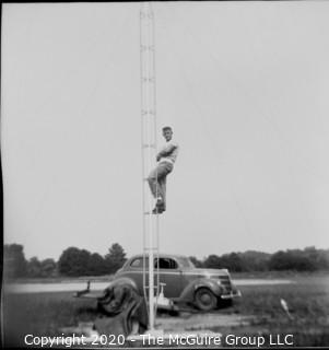 2 1/4 x 2 1/4" Film Negative Historical: Americana: 1950s?: Man on antennae w/ car in  bkg.