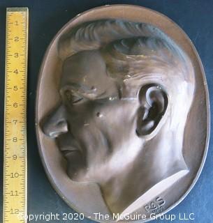 Large Plaque Made of Plaster with Copper Color Paint of Man in Profile.  Signed RAS 1933 with Wall Hanger.  Measures Approximately 12" Long.