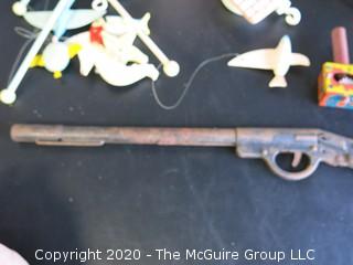 Group of Vintage Children's Toys and Mobile.
Includes Metal Toy Rifle & Three Pressed Tin Noise Makers, 