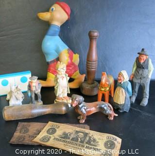 Group of Miscellaneous Items.  Includes Wood Juggling Pins, Carved Figures, Porcelain Figures, Faux Money and Large Duck Toy Made by Remple of Akron OH.