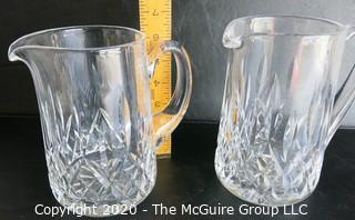 Set of Two Crystal Pitchers. Measure approximately 6 1/2" tall.  Some damage on one of the handles.
