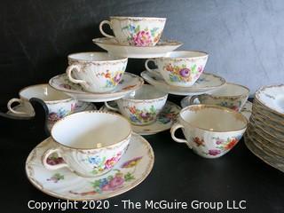 Partial Set of Dresden China China with Floral Decoration and Gold Gilt Edges.  