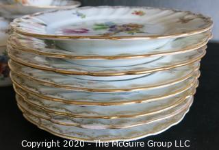 Partial Set of Dresden China China with Floral Decoration and Gold Gilt Edges.  