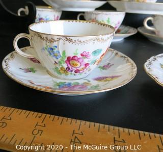 Partial Set of Dresden China China with Floral Decoration and Gold Gilt Edges.  