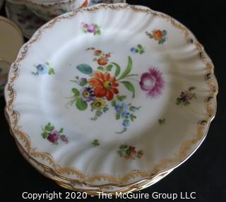 Partial Set of Dresden China China with Floral Decoration and Gold Gilt Edges.  