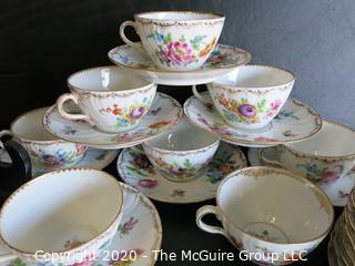 Partial Set of Dresden China China with Floral Decoration and Gold Gilt Edges.  