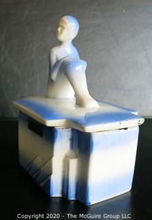 Blue and White Art Deco Pottery Talcom Powder Box with Figure on Lid.  Some chips on edges. .  Measures approximately 5 1/2" x 5".
