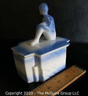 Blue and White Art Deco Pottery Talcom Powder Box with Figure on Lid.  Some chips on edges. .  Measures approximately 5 1/2" x 5".
