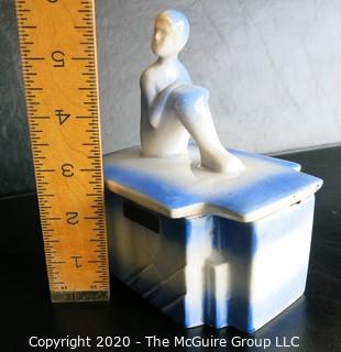 Blue and White Art Deco Pottery Talcom Powder Box with Figure on Lid.  Some chips on edges. .  Measures approximately 5 1/2" x 5".
