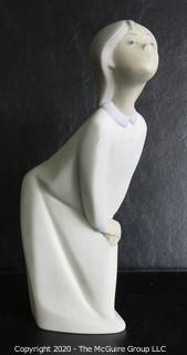 Vintage Lladro Porcelain Figurine of Child in Nightgown. Measures approximately 7" tall.