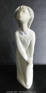 Vintage Lladro Porcelain Figurine of Child in Nightgown. Measures approximately 7" tall.