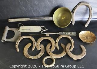 Large Group of Heavy Cast Iron and Brass Tools.  Includes Horseshoes, Hanging Scale with Brass Front, Brass Ladle, Scraper, Mule Shoe, Etc.