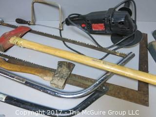 Collection of tools including Craftsman polisher/sander, axe and various saws