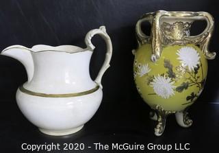 Large Ceramice Pitcher with Gilt Decoration and Yellow Urn Style Vase with White Floral Decoration.  Measures approximately 14". 