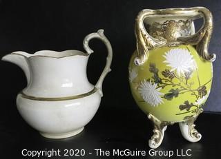 Large Ceramice Pitcher with Gilt Decoration and Yellow Urn Style Vase with White Floral Decoration.  Measures approximately 14". 