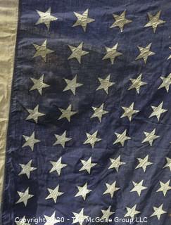 Antique 48 Star American Flag with Stitched Stripes and Stars.  Damage in the bottom corner that has been repaired. Measures approximately 45 x 67".