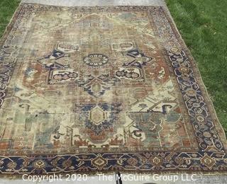 Hand Knotted Wool Rug with Blue Ground.  Poor condition with some holes and much wear.  Measures approximately 133" x 115"