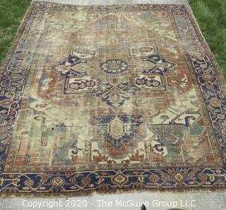 Hand Knotted Wool Rug with Blue Ground.  Poor condition with some holes and much wear.  Measures approximately 133" x 115"