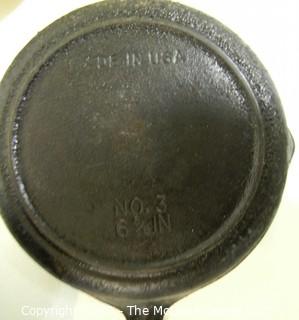 Collection of kitchenware including cast iron fry pans