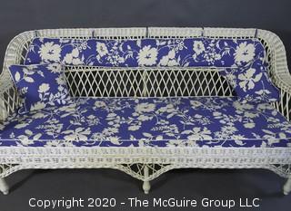 Antique Wicker Settee Sofa or Couch with Blue and White Cushions.  