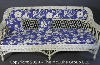 Antique Wicker Settee Sofa or Couch with Blue and White Cushions.  