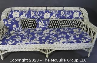 Antique Wicker Settee Sofa or Couch with Blue and White Cushions.  