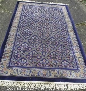 Chinese, Circa 1935, Hand Knotted Wool on Wool Featuring Rectangular Field with Diamond Shaped Car touches Filled with Multi Colored Florettes on Dark Blue Ground.  Measures approximately 108" x 72". Some staining and discoloration. 