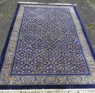 Chinese, Circa 1935, Hand Knotted Wool on Wool Featuring Rectangular Field with Diamond Shaped Car touches Filled with Multi Colored Florettes on Dark Blue Ground.  Measures approximately 108" x 72". Some staining and discoloration. 