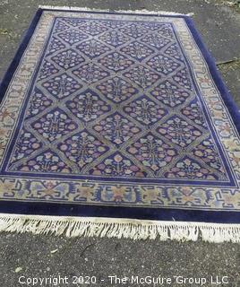 Chinese, Circa 1935, Hand Knotted Wool on Wool Featuring Rectangular Field with Diamond Shaped Car touches Filled with Multi Colored Florettes on Dark Blue Ground.  Measures approximately 108" x 72". Some staining and discoloration. 