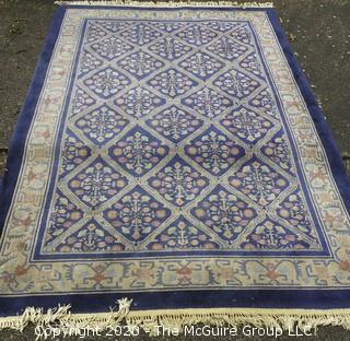 Chinese, Circa 1935, Hand Knotted Wool on Wool Featuring Rectangular Field with Diamond Shaped Cartouches Filled with Multi Colored Florettes on Dark Blue Ground.  Measures approximately 108" x 72". Some staining and discoloration. 