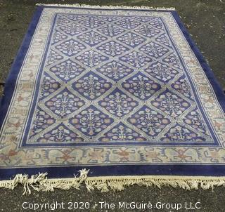 Chinese, Circa 1935, Hand Knotted Wool on Wool Featuring Rectangular Field with Diamond Shaped Cartouches Filled with Multi Colored Florettes on Dark Blue Ground.  Measures approximately 108" x 72". Some staining and discoloration. 