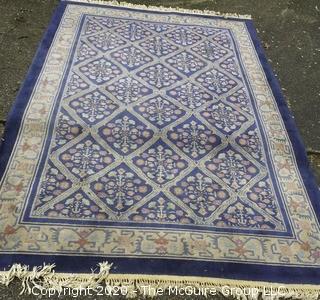 Chinese, Circa 1935, Hand Knotted Wool on Wool Featuring Rectangular Field with Diamond Shaped Cartouches Filled with Multi Colored Florettes on Dark Blue Ground.  Measures approximately 108" x 72". Some staining and discoloration. 