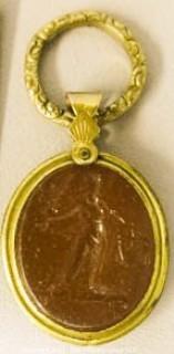 Italian 19th Century Hand Carved Cameo Set in Period Gold Filled Bezel with Rope Banding.  Image of Greek Woman with Garlands in her Hair.  Measures 2" x 1 1/8". 