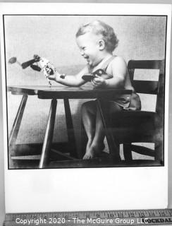 Black & White Photo - Child in High Chair by Sara Langston. Measures 16" x 20" and mounted on picture board.