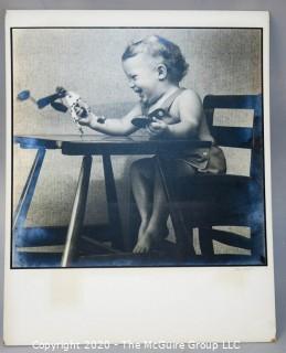 Black & White Photo - Child in High Chair by Sara Langston. Measures 16" x 20" and mounted on picture board.