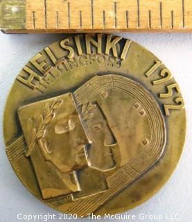 1952 Helsinki XV Summer Olympics Bronze Participation Medal. Designed by Kauko Rasanen and minted by Veljekset Sundqvist Oy in Helsinki it measures approximately 2 1/2 in diameter.