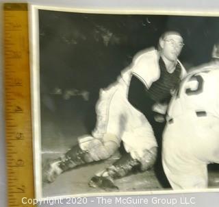 Black & White Photo of Impending Home Plate Collision.  Believed to be a Rickerby photo; who pioneered the use of 35mm film with telephoto lenses to capture sports action stills.  Measures approximately 8" x 10". 