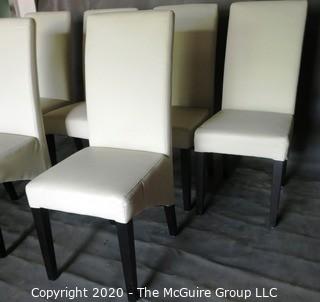 Set of 6 White Faux Leather Dining Chairs with Black Wooden Legs; 1 chair has 4" vertical rip near top of back.  (Description altered 7/29/20 @ 18:39 ET)