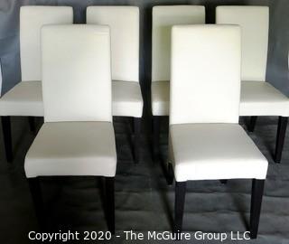 Set of 6 White Faux Leather Dining Chairs with Black Wooden Legs; 1 chair has 4" vertical rip near top of back.  (Description altered 7/29/20 @ 18:39 ET)