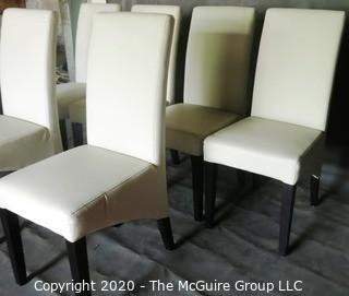 Set of 6 White Faux Leather Dining Chairs with Black Wooden Legs; 1 chair has 4" vertical rip near top of back.  (Description altered 7/29/20 @ 18:39 ET)