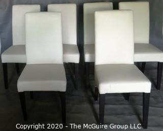 Set of 6 White Faux Leather Dining Chairs with Black Wooden Legs; 1 chair has 4" vertical rip near top of back.  (Description altered 7/29/20 @ 18:39 ET)