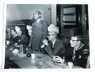 Photo: Historical: Fairfax VA: undated: Boy Scouts of America meeting with members wearing novelty paper hats and a black person speaking