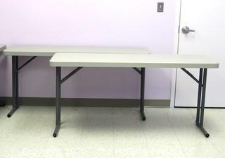 Set of (2) Industrial Heavy Duty Plastic Folding Tables Made by National Public Seating.   There are four lots of these tables for a total of 8 tables .  Each measure approximately 18" W, 30" T  & 60" long.  Room 20 Kitchen