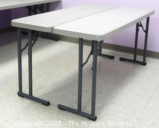 Set of (2) Industrial Heavy Duty Plastic Folding Tables Made by National Public Seating.   There are four lots of these tables for a total of 8 tables .  Each measure approximately 18" W, 30" T  & 60" long.  Room 20 Kitchen